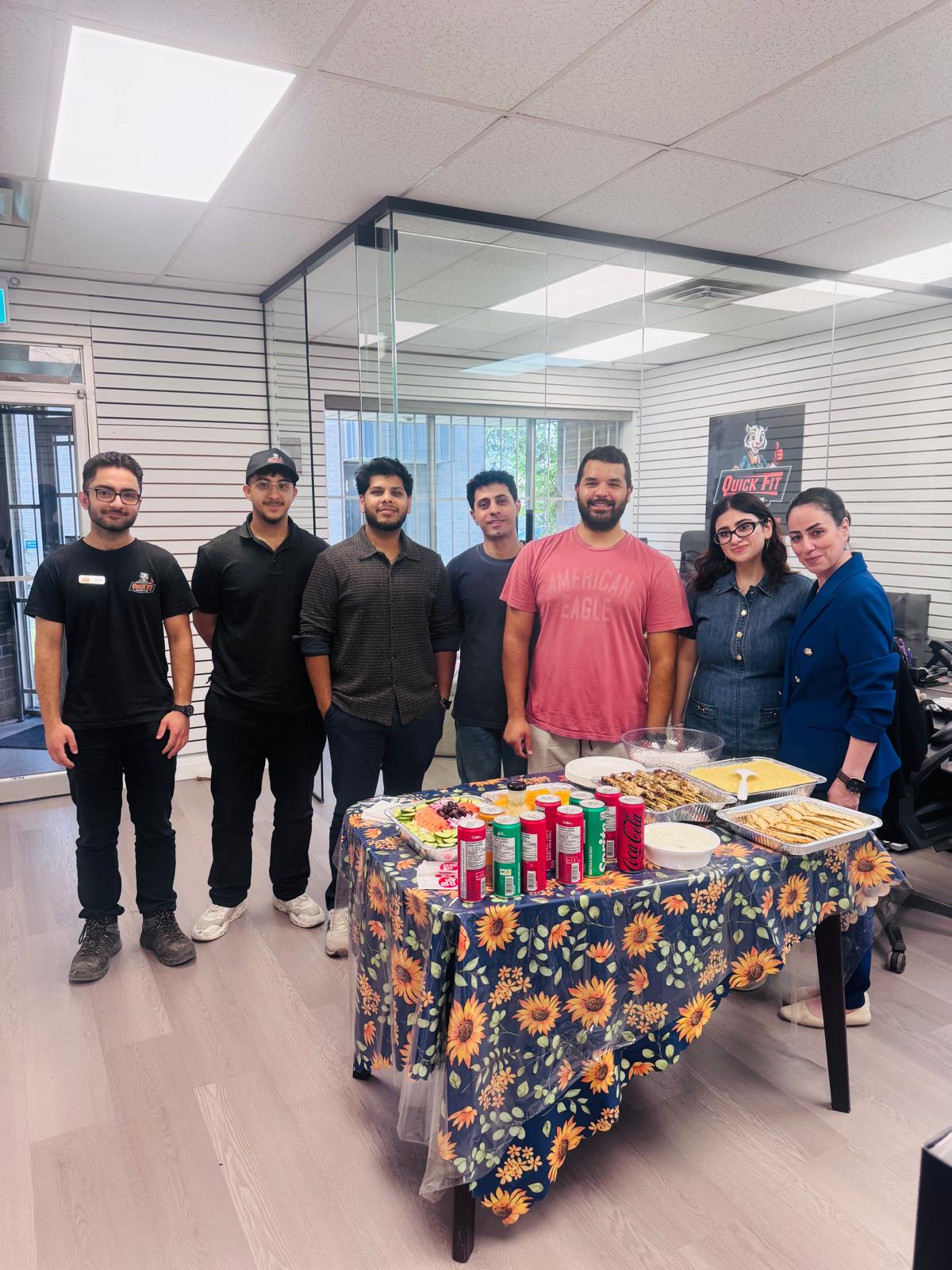 The Quick Fit Parts team gathered around the table
